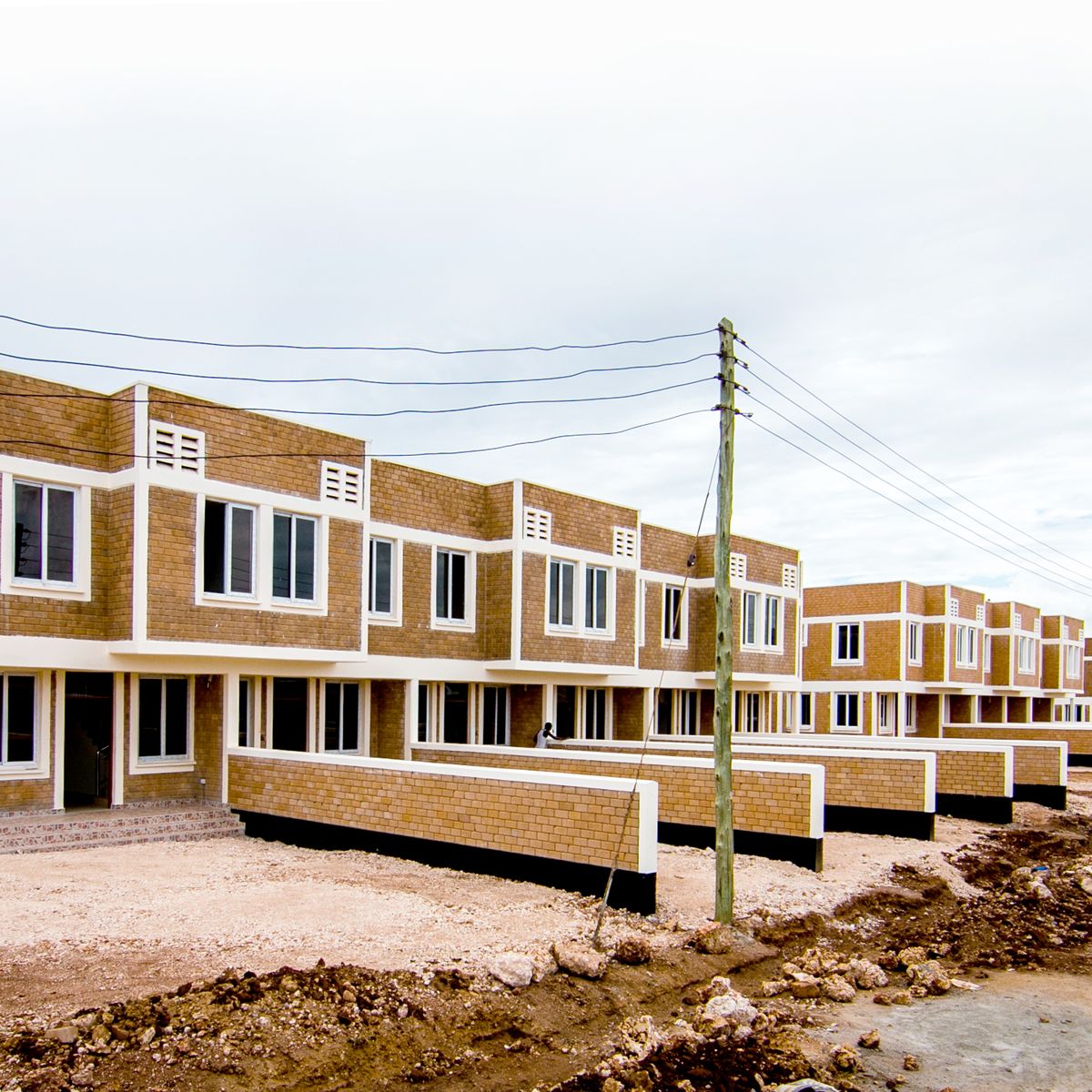Close view of an apartment block frontage with boundary walls at Mwongozo