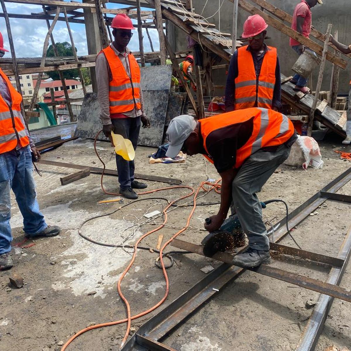 Site team cutting steel sections during fabrication works